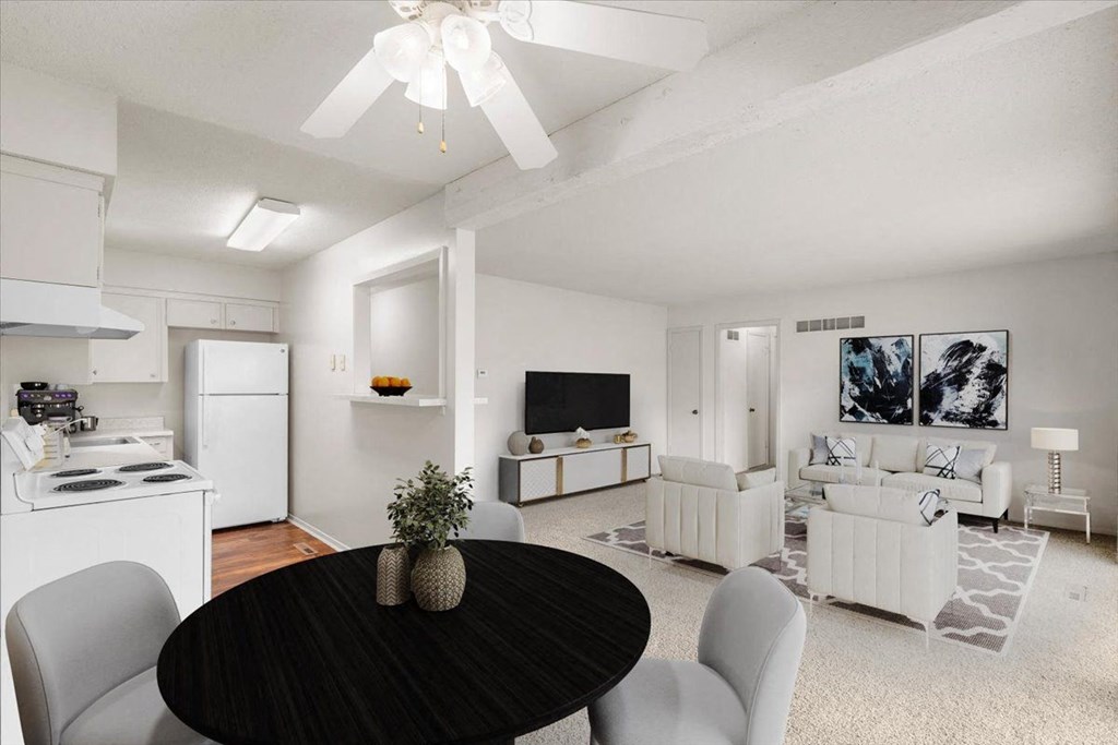 Dining table with living room view  at Louisburg Square Apartments & Townhomes, Overland Park, Kansas