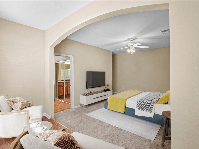 a bedroom with a bed and a tv