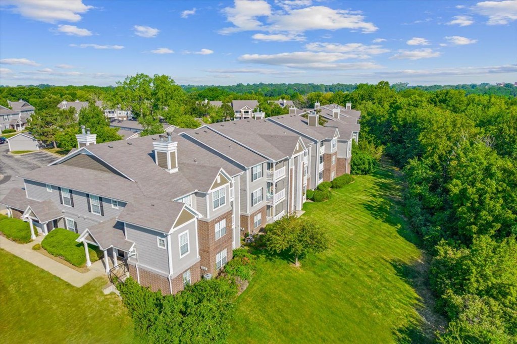 an aerial view of a row of houseat Stonebriar Woods Apartments, Overland Park, KSs in a grassy area