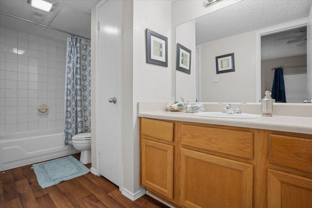 a bathroom with a toilet sink and shower at Creekview Apartment Homes, Texas