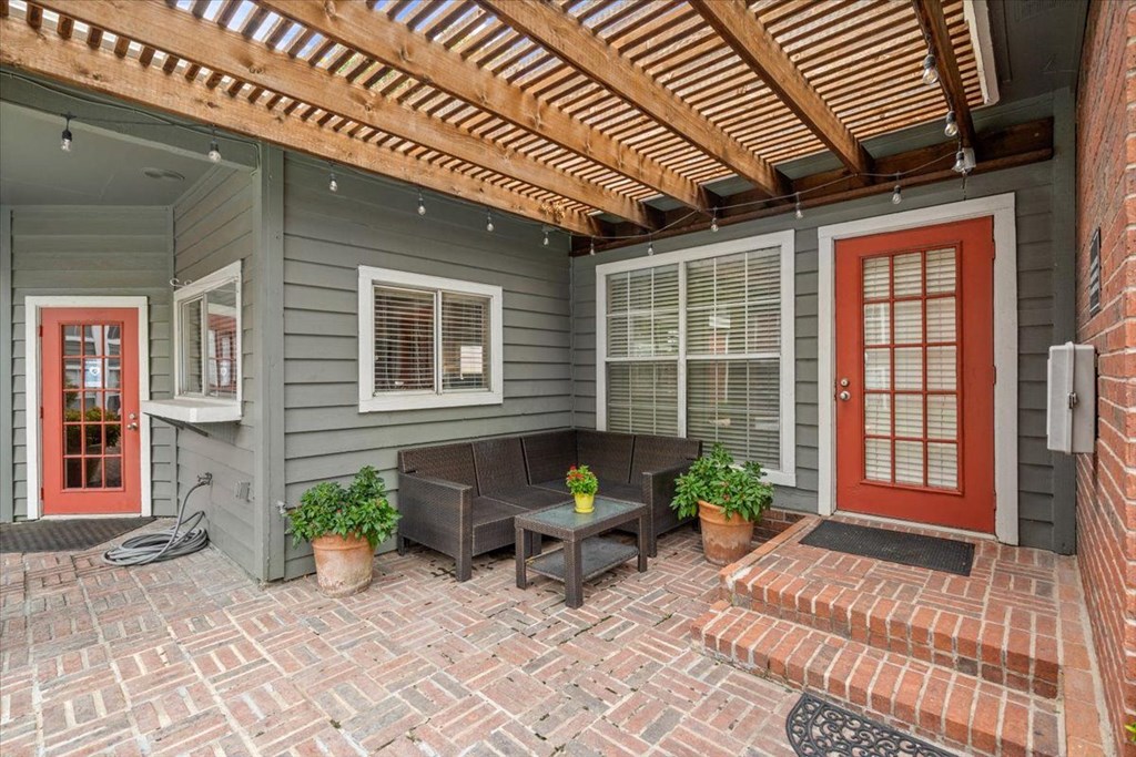 a house with a red door and a brick patio at Pear Ridge, Texas, 75287