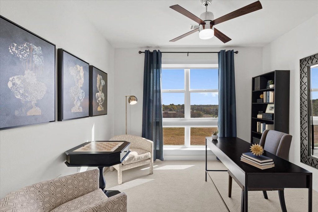 an office with a large window and a desk