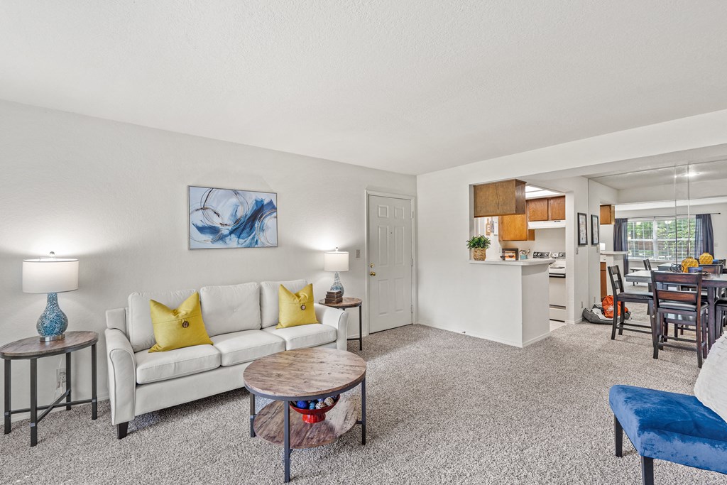 a living room with a white couch and yellow pillows at Pebblebrook, Kansas