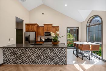 A kitchen with a black and white patterned bar.