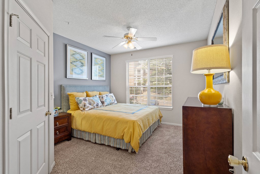 a bedroom with a bed and a ceiling fan  at Claremont, Overland Park