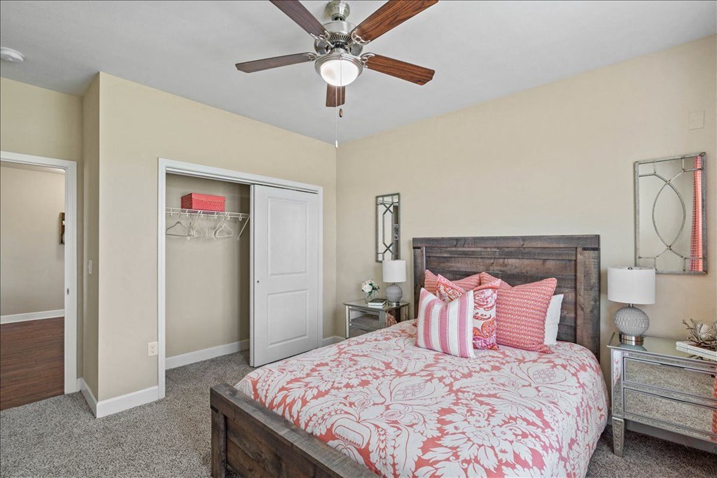 a bedroom with a bed and a ceiling fan