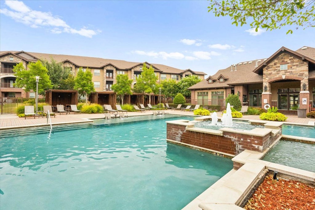 the preserve at ballantyne commons community pool and hot tub with apartment buildings in the background