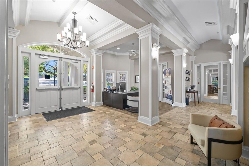 A spacious room with a tiled floor and a chandelier hanging from the ceiling. at Somerset Oaks Apartment Homes, Olathe, Kansas