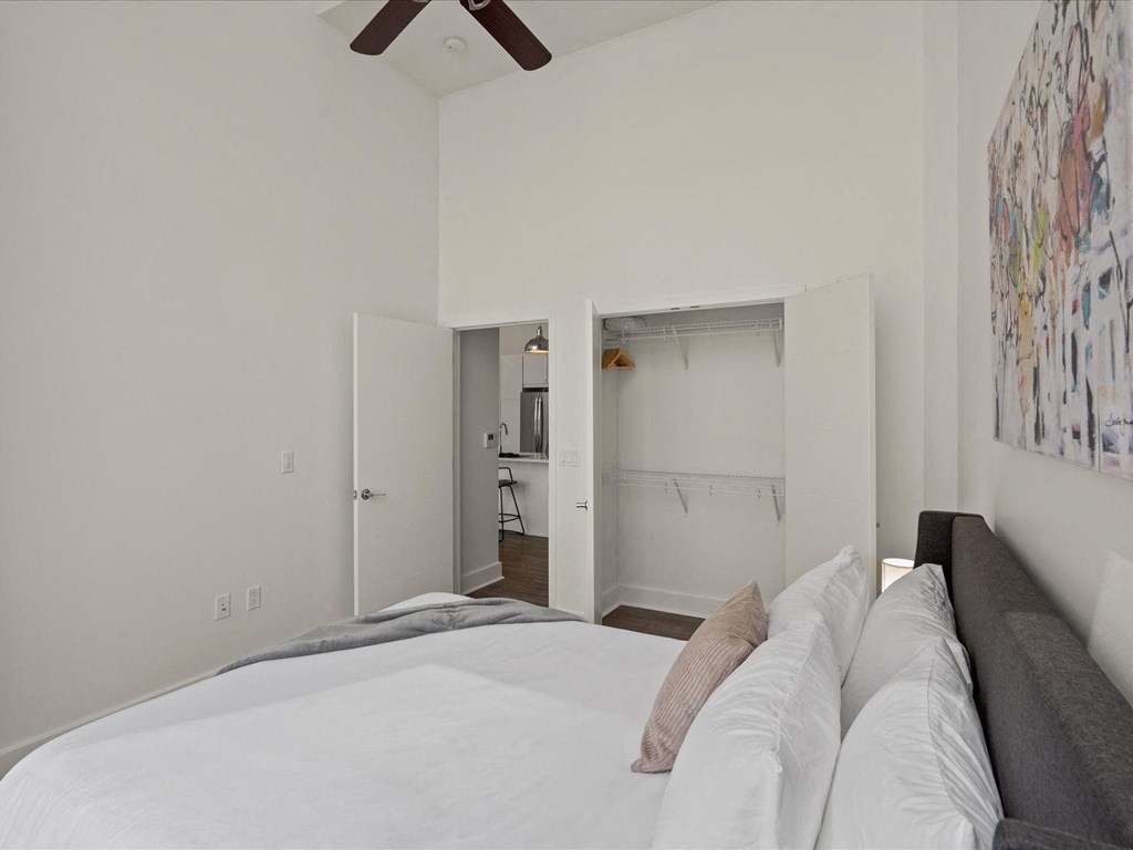 a bedroom with a large bed and a ceiling fan