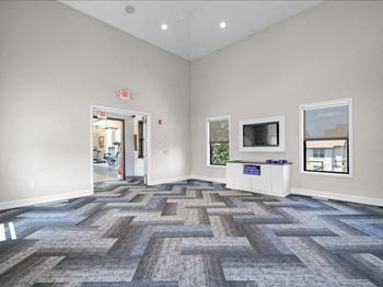 a living room with a tv and a door to a hallway