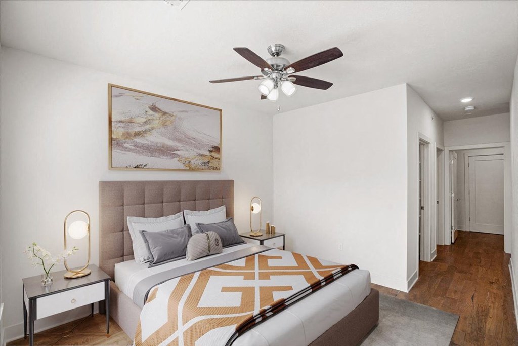 A bedroom with a ceiling fan and hallway closet at Mirabelle Luxury Apartments, Missouri, 64111