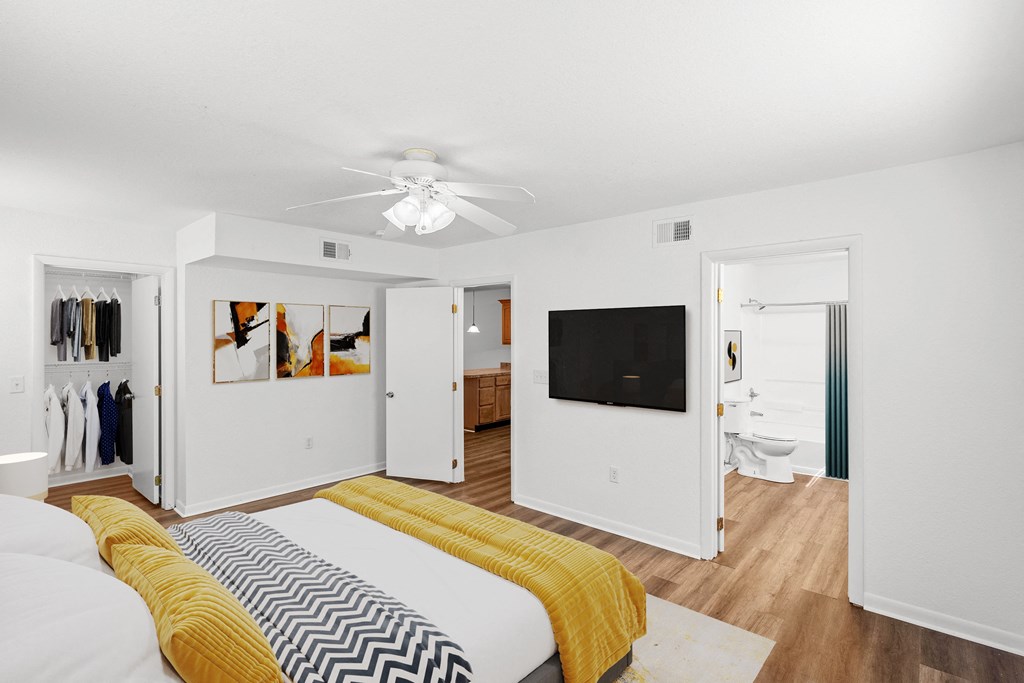 a bedroom with a bed and a ceiling fan at Malvern Hill Apartment Homes, 66103 66214