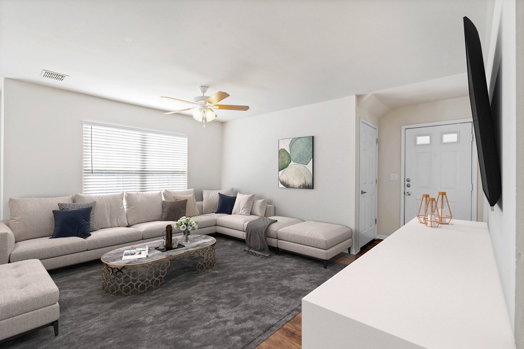 a living room with a large couch and a coffee tableat Stonebriar Woods Apartments, Overland Park