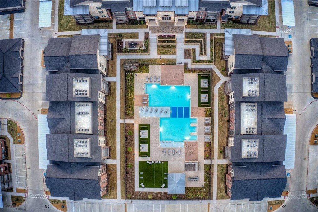 arial view of a house with a pool in the middle
