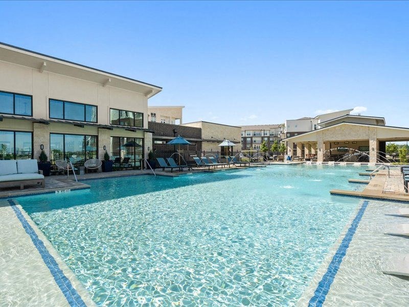 a large swimming pool in front of a building