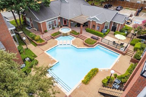 a swimming pool with a fountain in front of a house at Pear Ridge, Dallas