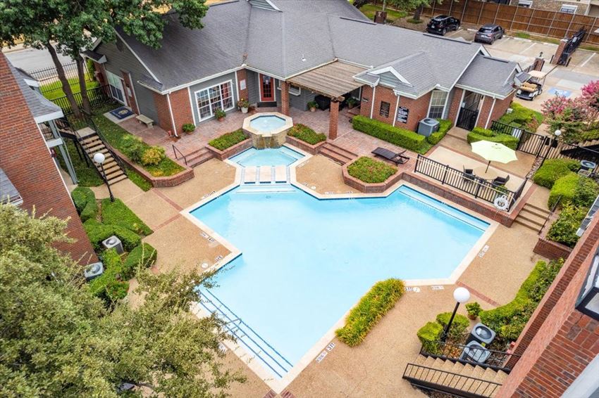 a swimming pool with a fountain in front of a house a swimming pool with a fountain in front of a house at Pear Ridge, Dallas