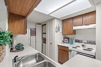 a kitchen with white countertops and a stainless steel sink at Pebblebrook, Kansas, 66212