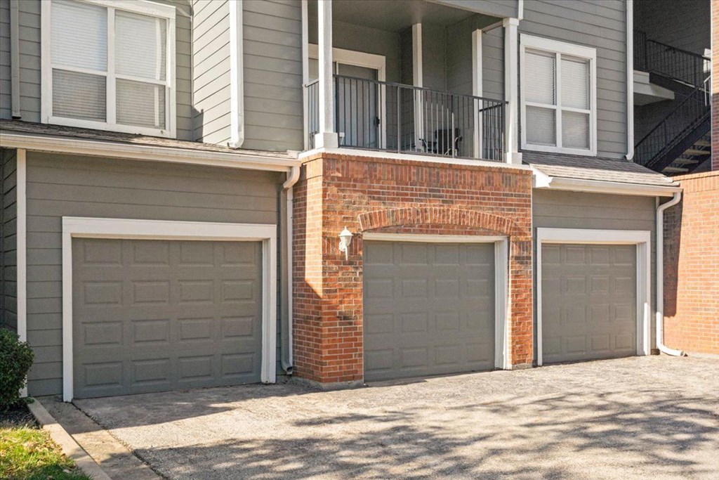 Two garage doors are closed in front of a brick wall. at Somerset Oaks Apartment Homes, Olathe 66062