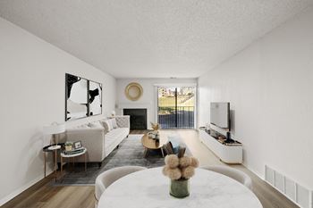 A modern living room with a fireplace and a large mirror on the wall.