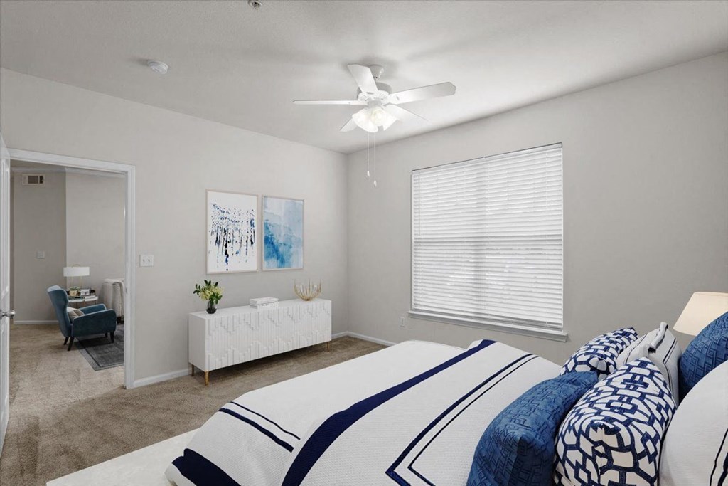 a bedroom with a large bed and a ceiling fan a bedroom with a large bed and a ceiling fan at Stonepost Lakeside, Olathe, KS, 66062