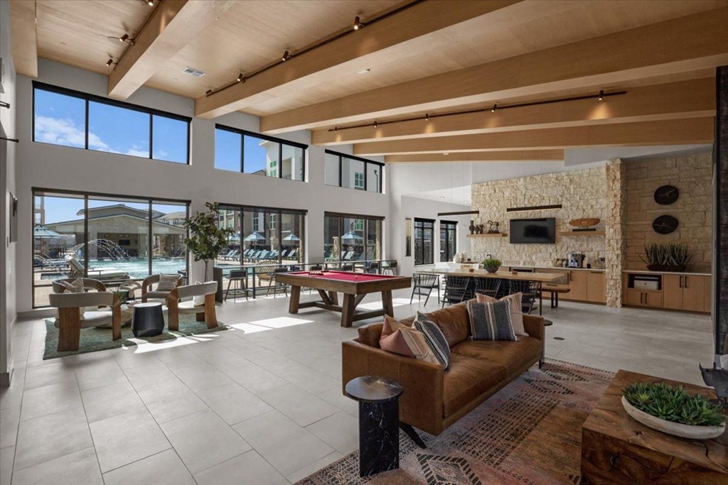 a large living room with a pool table and a fireplace