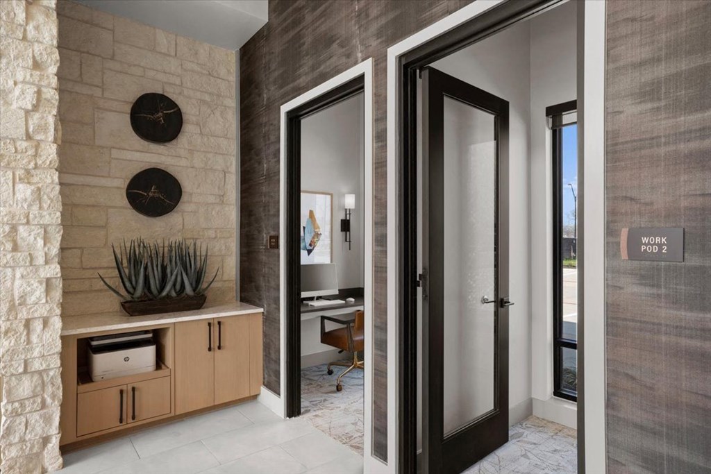 the doors to the office are open to the lobby of the house