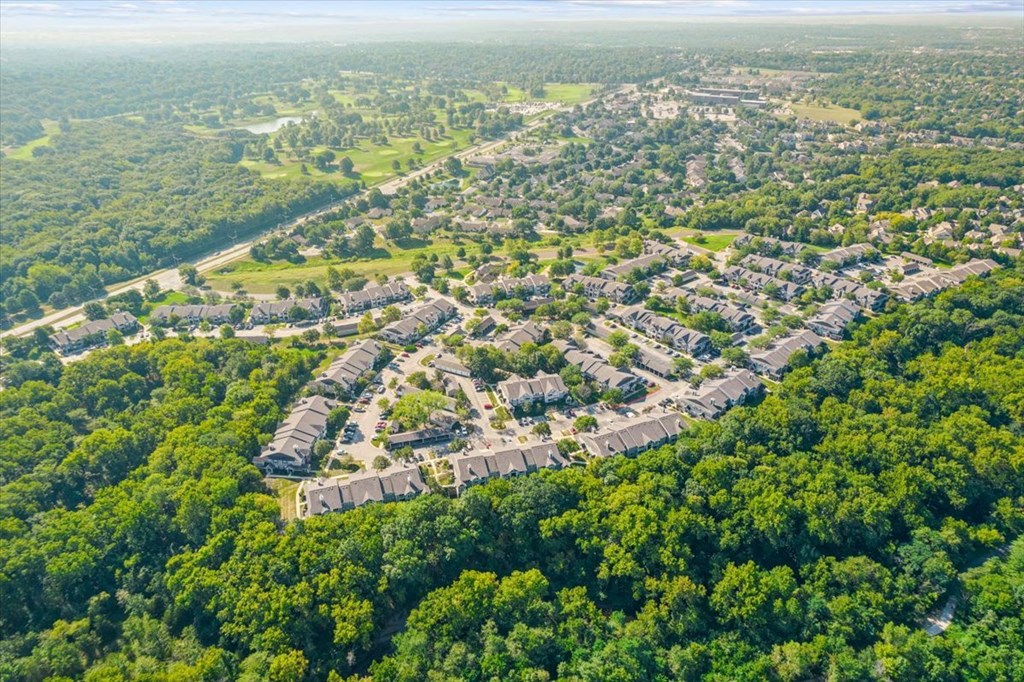 an aerial view of a neighborhood surrounded by treesat Stonebriar Woods Apartments, Overland Park, KS