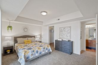 a bedroom with a bed and a dresser at Waterford Place Apartments & Townhomes, Kansas, 66210