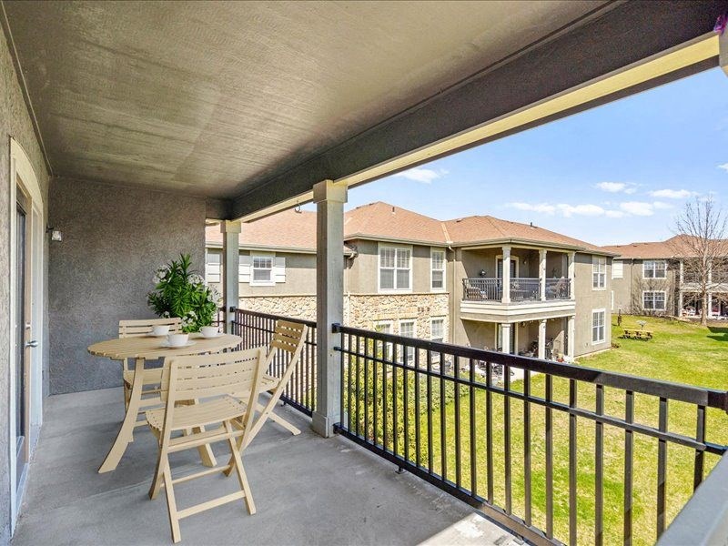 a patio with a table and chairs on a balcony