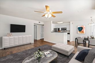 a living room with white walls and a ceiling fanat Stonebriar Woods Apartments, Kansas, 66213