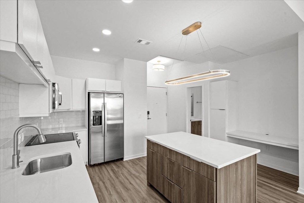 a kitchen with a white counter top at Sky On Main Apartments, Missouri City, Missouri