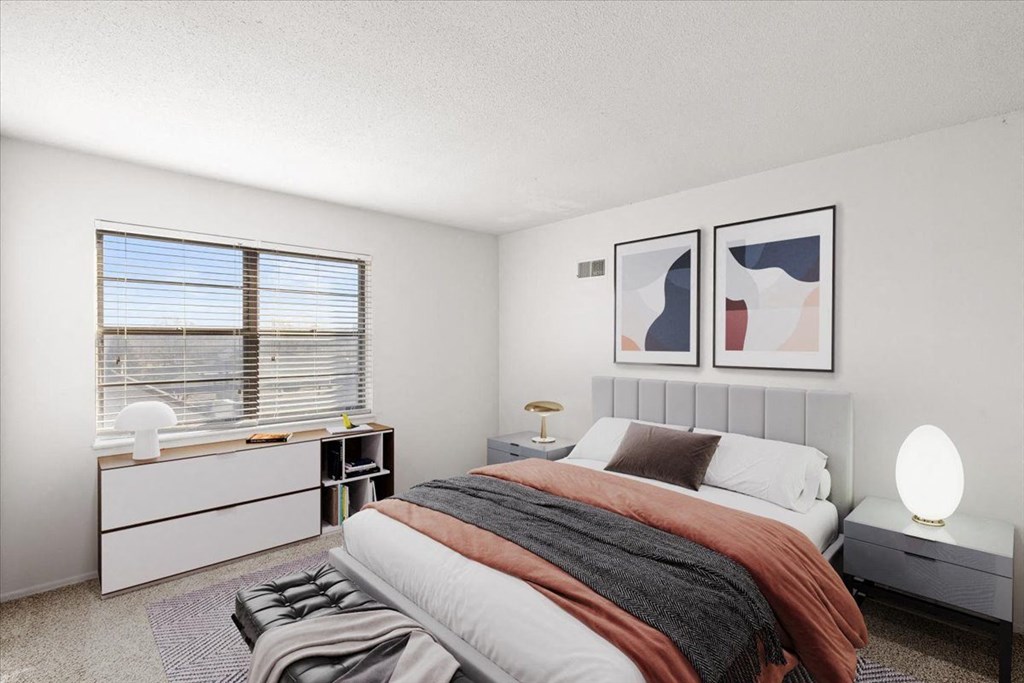 a bedroom with a bed and a window