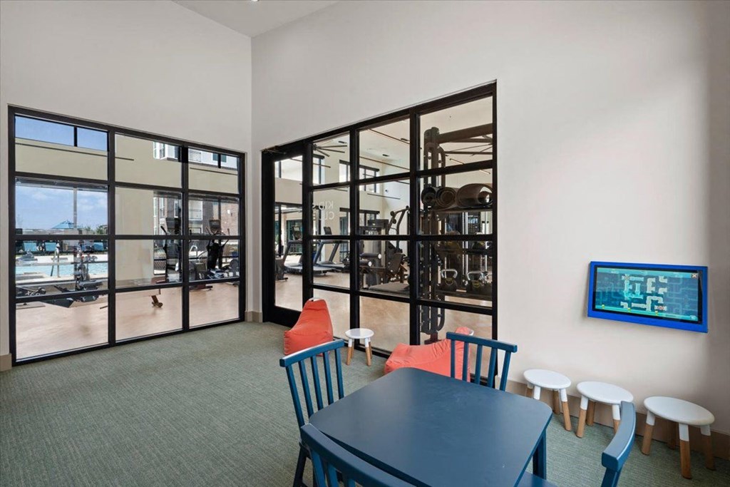 a dining room with a table and chairs and a tv