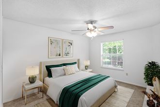 a bedroom with a bed and a ceiling fanat Stonebriar Apartments, Overland Park, Kansas