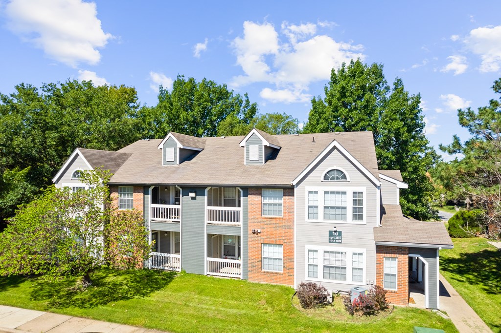 a house on a hill with trees in the backgroundat Stonebriar Apartments, Overland Park, Kansas