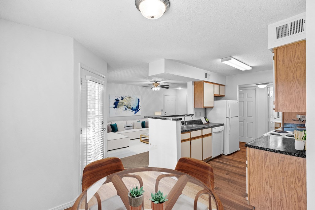 a kitchen and living room in a 555 waverly unit a kitchen and living room in a 555 waverly unitat Stonebriar Apartments, Overland Park, KS, 66213