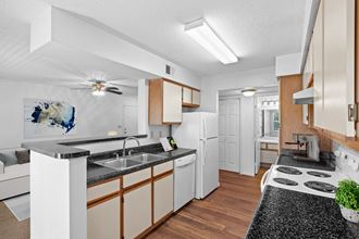 a kitchen with white appliances and wooden cabinetsat Stonebriar Apartments, Kansas, 66213