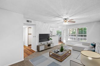 a living room with white walls and a ceiling fanat Stonebriar Apartments, Overland Park, KS