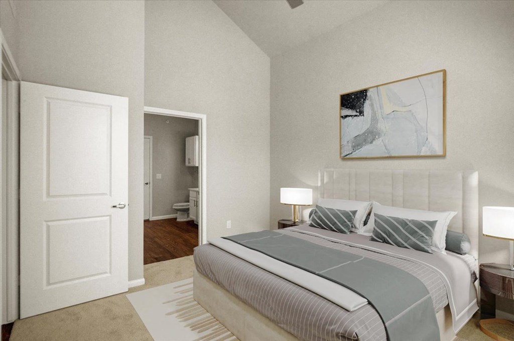 a bedroom with a bed and a door to a bathroom