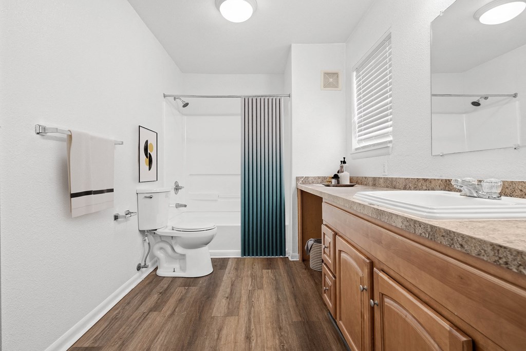 a bathroom with a toilet sink and bathtub at Malvern Hill Apartment Homes, 66103, KS