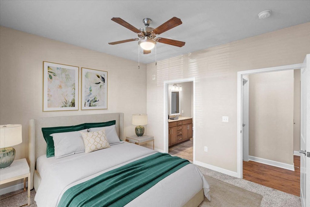 a bedroom with a bed and a ceiling fan