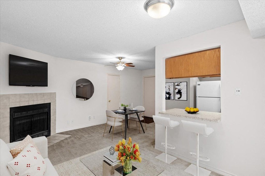 a living room with a kitchen and a dining room at Wind River Lodge, Lenexa, KS