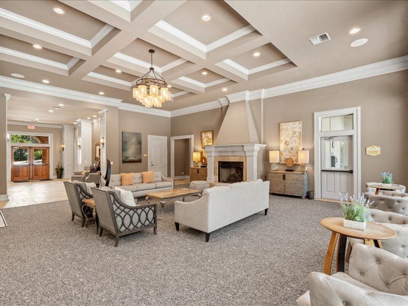 a living room with couches and chairs and a fireplace