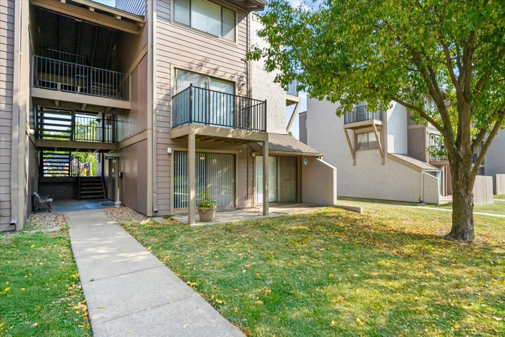 Apartment building with a tree in front.