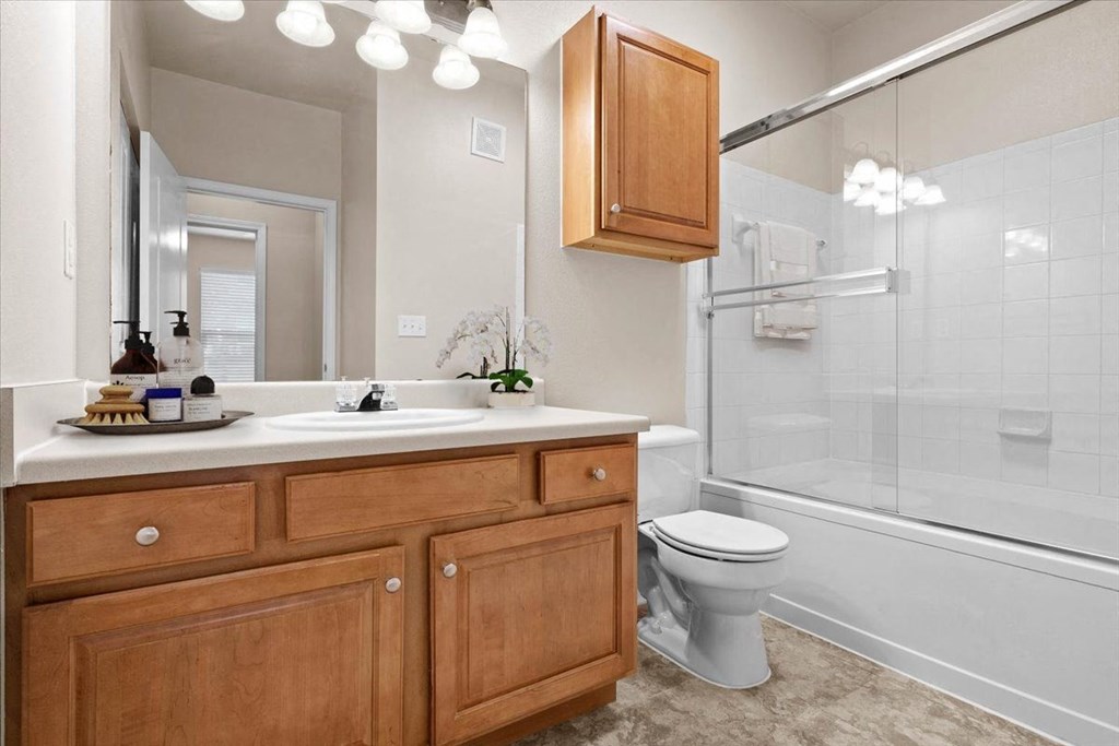 a bathroom with a sink toilet and a shower