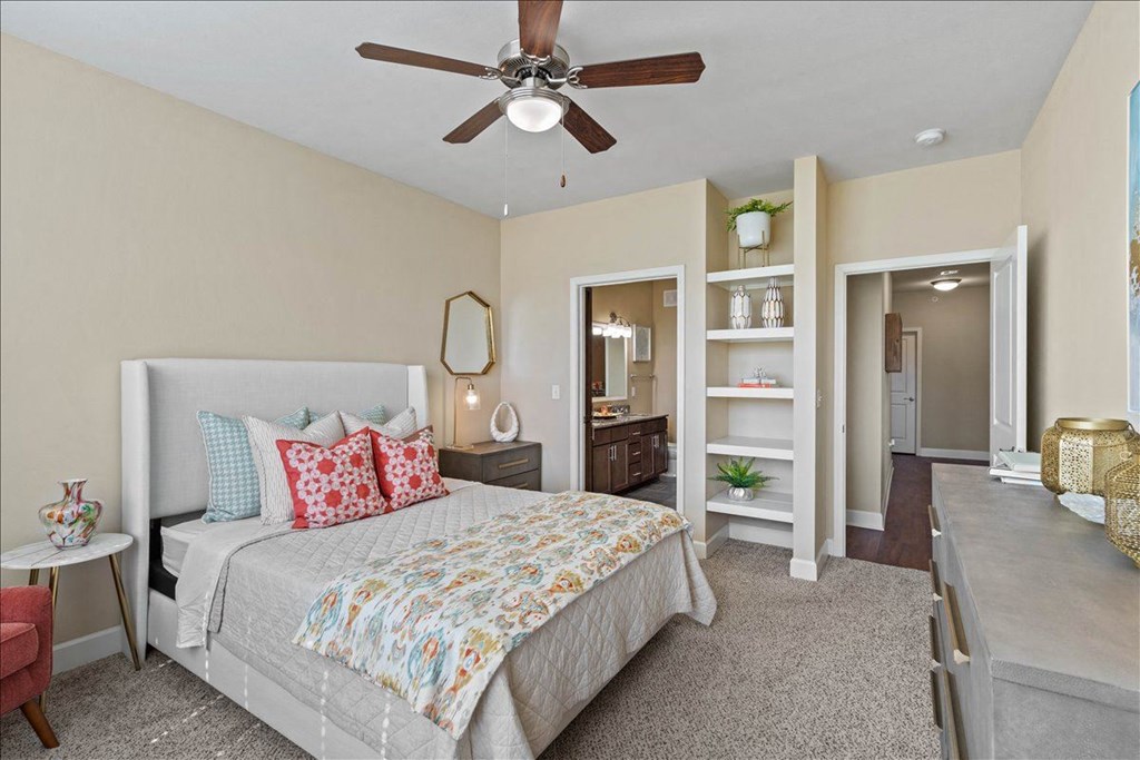 a bedroom with a bed and a ceiling fan