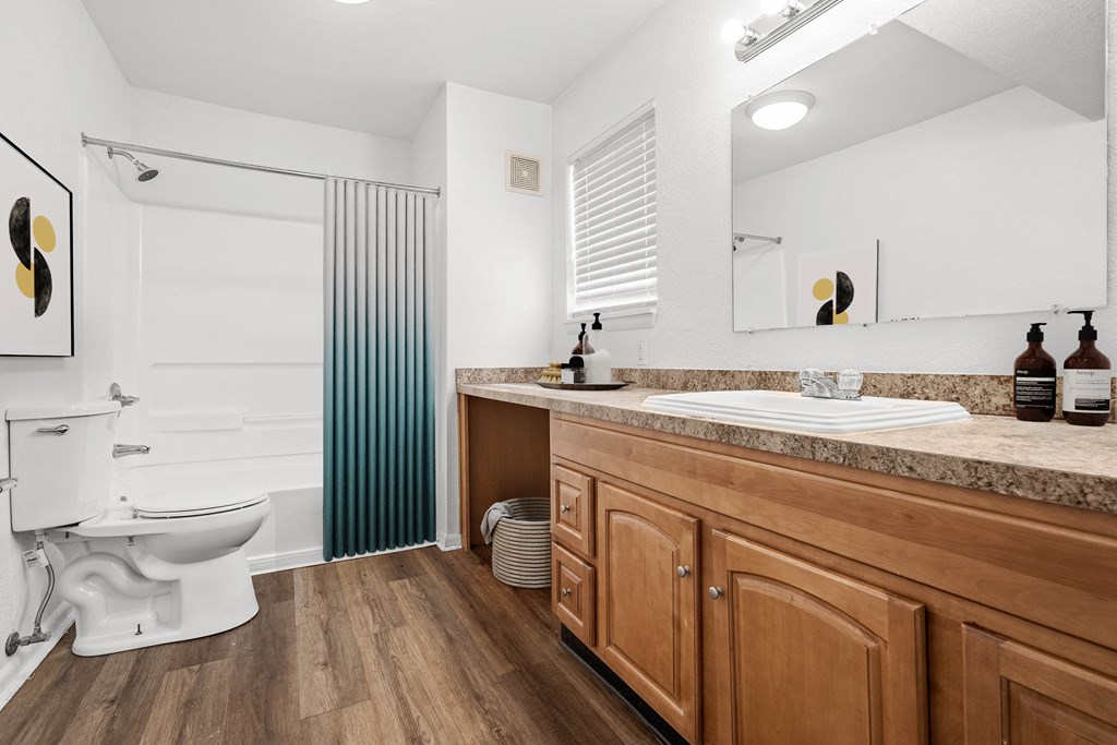 a bathroom with a toilet sink and shower at Malvern Hill Apartment Homes, 66103, KS, 66214