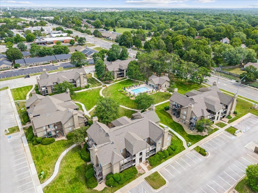 an aerial view of houses in a neighborhood with a swimming pool