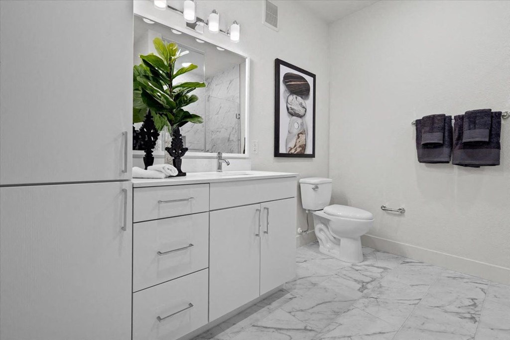 a white bathroom with a sink and a toilet